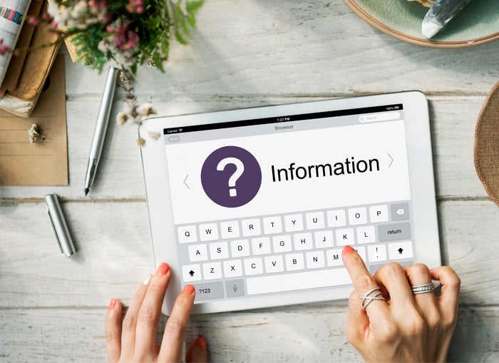 Person using a tablet to search for business information online, representing the challenges caused by inconsistent NAP (Name, Address, Phone) data in healthcare SEO.