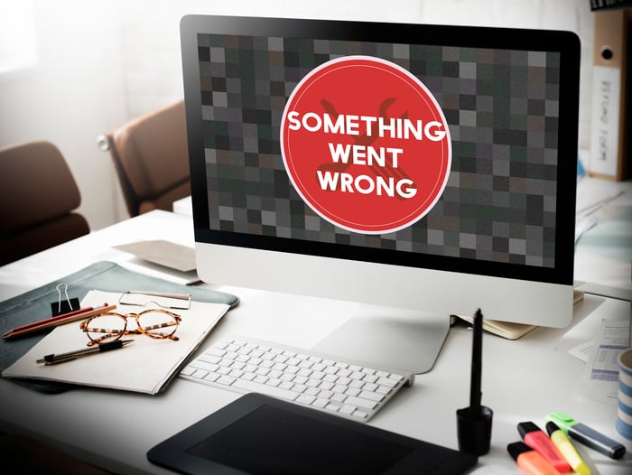 A desktop screen showing a bold red error message “Something Went Wrong” in a medical office setting—illustrating the risks and unreliability often associated with paid advertising compared to the long-term stability of SEO for doctors.