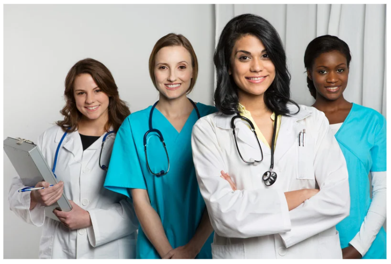 Group of confident female doctors and nurses smiling together, representing collaboration and success in healthcare—symbolizing the conclusion on winning the digital race in OBGYN care.