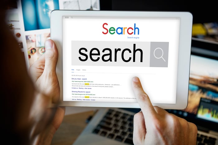 Awareness and Discovery stage visual: User conducting the initial search for answers on a tablet, engaging with search engine optimization (SEO) results.