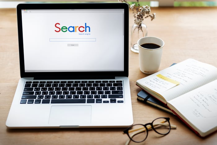 Search engine homepage on a laptop with notes and coffee, representing how Google evaluates website performance and SEO effectiveness for doctors and medical practices.