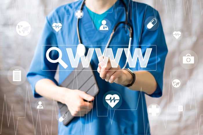 Doctor pressing a virtual search icon, representing the importance of medical practice website design for online visibility and patient acquisition.