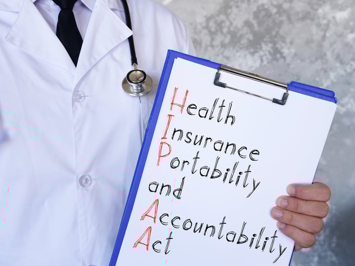 HIPAA compliance concept with a stethoscope, clipboard, and labeled folder, symbolizing secure data practices across the healthcare marketing funnel.