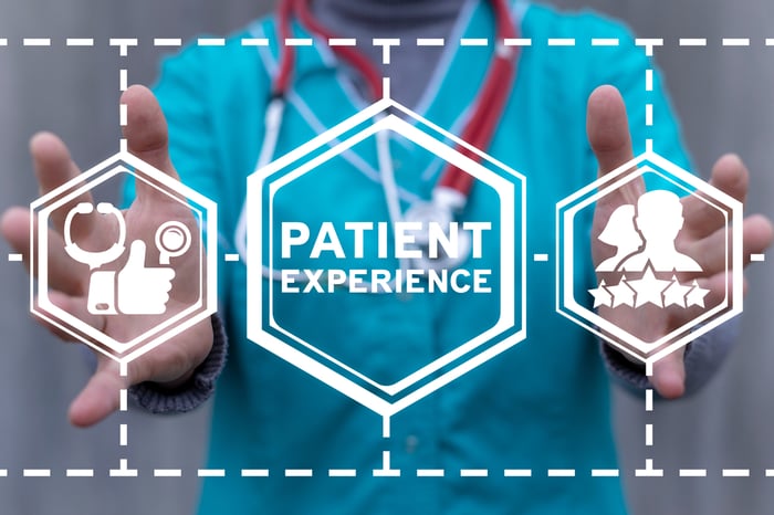 Doctor holding a digital feedback interface, symbolizing patient reviews and online reputation management in healthcare.