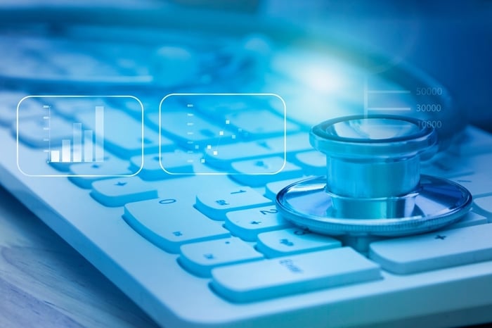 Stethoscope on computer keyboard with digital analytics graphics — symbolizing how data-driven digital marketing helps private practices future-proof growth.
