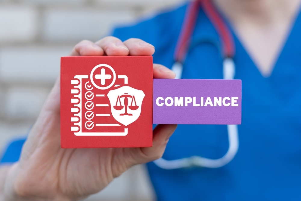 Doctor highlighting importance of compliance in medical website development with icons for security, accessibility, and regulations.