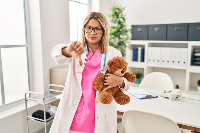Female pediatrician giving a thumbs down, illustrating frustration and the struggle faced by pediatric practices due to high no-show rates in 2025.