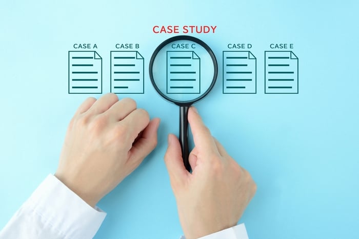 A medical professional examining a healthcare SEO agency case study under a magnifying glass, illustrating how PracticeBeat engineered a $2M growth engine.