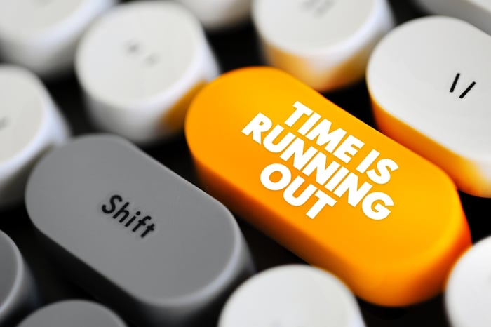Close-up of a keyboard with an orange key showing "TIME IS RUNNING OUT," illustrating the urgency for solo practices to adopt HIPAA-safe, AI-ready medical website development before regulatory deadlines.