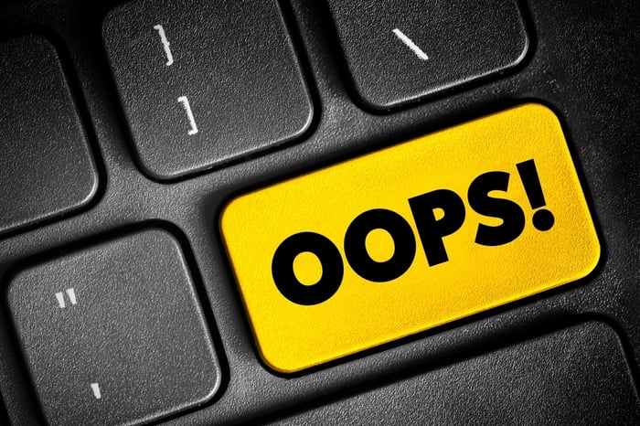 PracticeBeat medical website design analysis showing an "OOPS!" button on a keyboard, representing common errors in healthcare website development that erode patient trust.