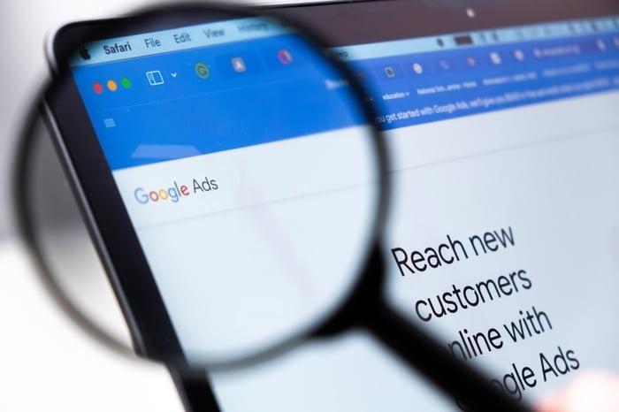 Google Ads for doctors – magnifying glass highlighting Google Ads dashboard on screen, representing digital marketing for doctors and paid advertising visibility.