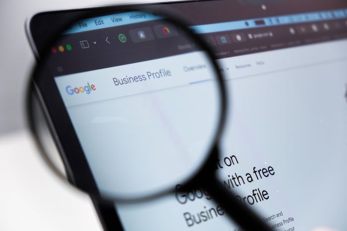 Close-up of Google Business Profile page under magnifying glass, emphasizing the role of local SEO for doctors and medical practices.