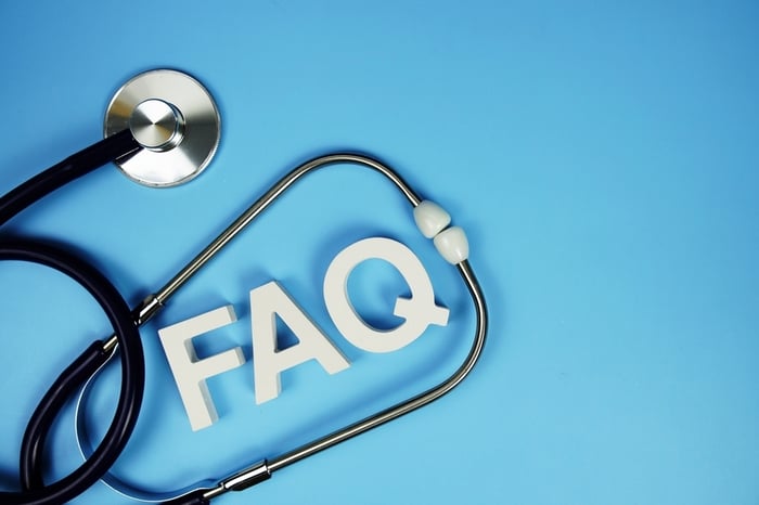 Stethoscope arranged around the letters FAQ on a blue background — representing frequently asked questions about Medical SEO for doctors.