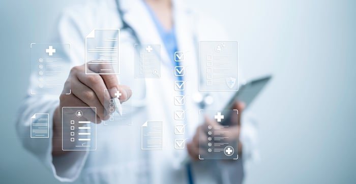 Doctor using a digital checklist interface with healthcare icons, symbolizing a reliable, secure, and efficient medical website development strategy that drives patient engagement and compliance.