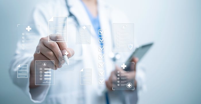 Doctor interacting with digital medical forms and checklists, symbolizing the evaluation process for choosing the right medical website development partner.