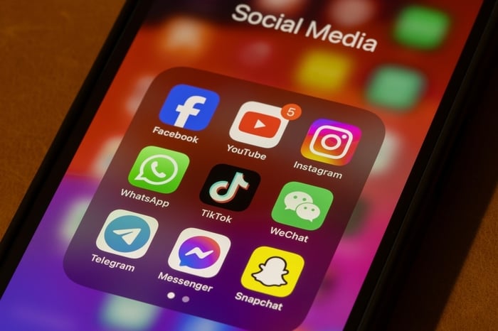 Smartphone screen displaying popular social media apps like Facebook, YouTube, Instagram, WhatsApp, TikTok, and Snapchat, representing digital engagement and online marketing opportunities for doctors.
