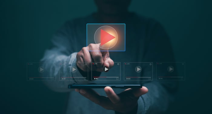 Person tapping a digital play button on a smartphone screen — symbolizing the growing dominance of video content in digital marketing for doctors in 2025.