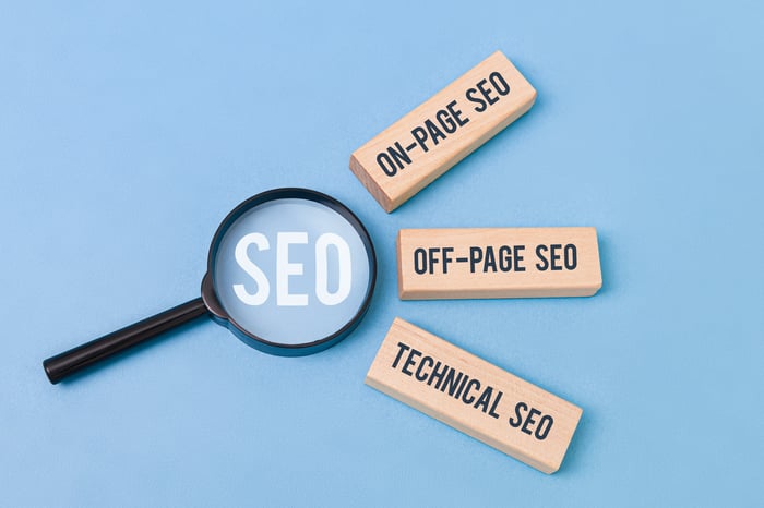 The 3 Pillars in SEO for Doctors — On-Page, Off-Page, and Technical SEO visual concept with magnifying glass and wooden blocks.