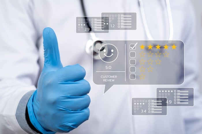 Healthcare professional giving a thumbs-up, symbolizing trust, credibility, and a strong reputation in medical website design.