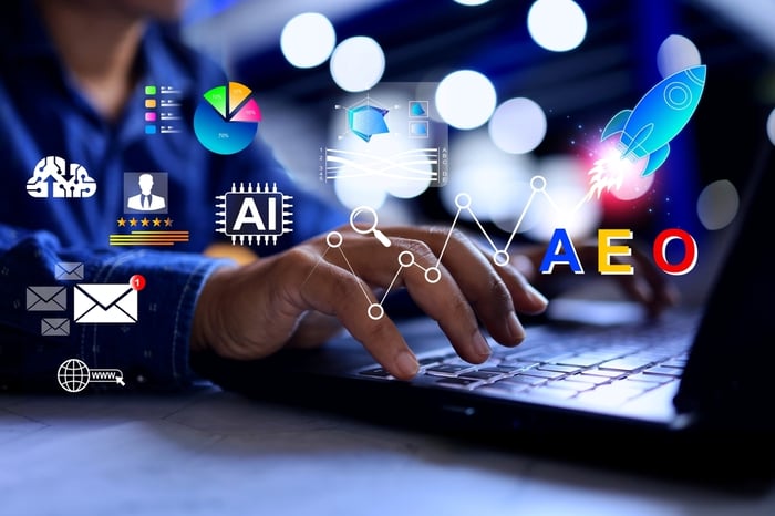 Professional interacting with a digital tablet displaying Answer Engine Optimization (AEO) and AI Optimization (AIO) concepts, representing AI-driven search and conversational answer visibility strategies for medical SEO and healthcare practices.