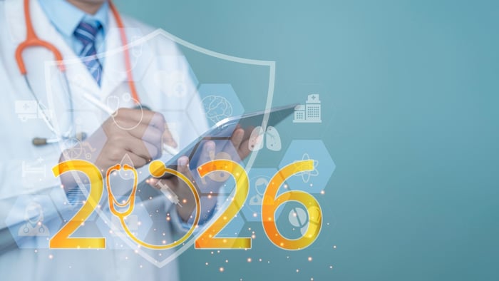 A professional medical provider in 2026 using a tablet with a glowing digital shield overlay and '2026' branding, representing the secure, data-driven dominance of Practicebeat in the modern healthcare landscape.