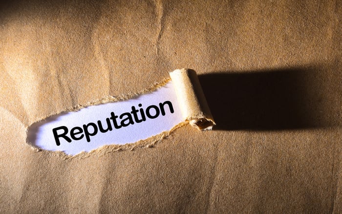 Reputation management concept with torn paper revealing the word Reputation — illustrating why trust and credibility are essential in digital marketing for private practice.
