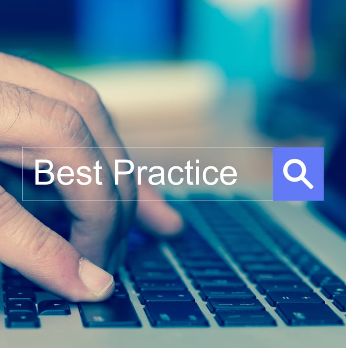 Close-up of a person typing on a keyboard with the words "Best Practice" displayed in a digital search bar, symbolizing the importance of following web design best practices for healthcare websites.