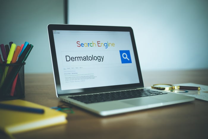 Laptop screen displaying a search engine with the keyword "Dermatology" in the search bar — representing local SEO strategies for dermatological services.