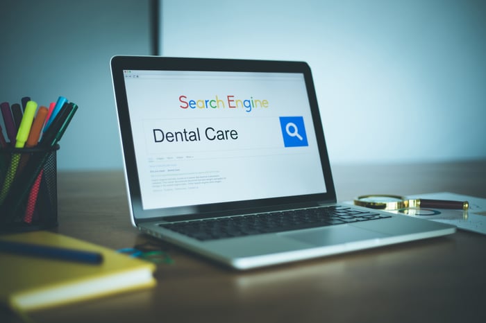 Laptop screen showing dental care search results, representing the importance of keyword research and SEO for medical practices