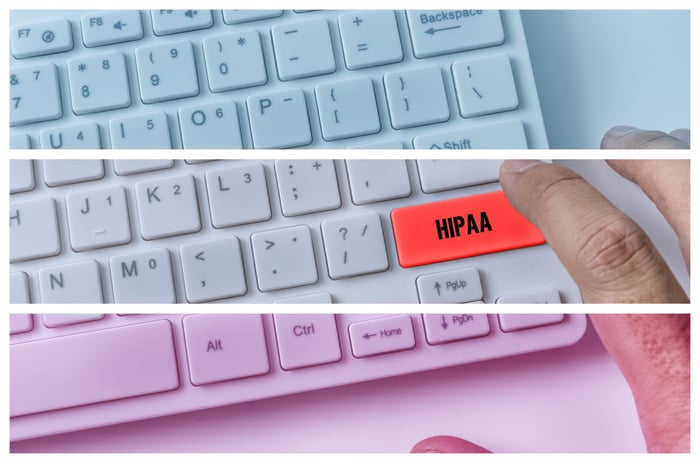 Close-up of a keyboard with a red HIPAA key being pressed, symbolizing the importance of HIPAA compliance in secure medical website development.