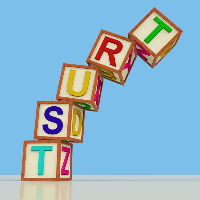 Colorful 3D alphabet blocks stacked to spell the word TRUST, symbolizing credibility and reliability in medical website development.