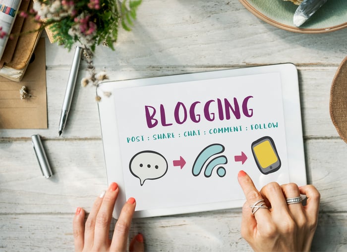 Tablet screen displaying the word blogging with icons for sharing and communication, symbolizing how allergists can grow their practice through blogs